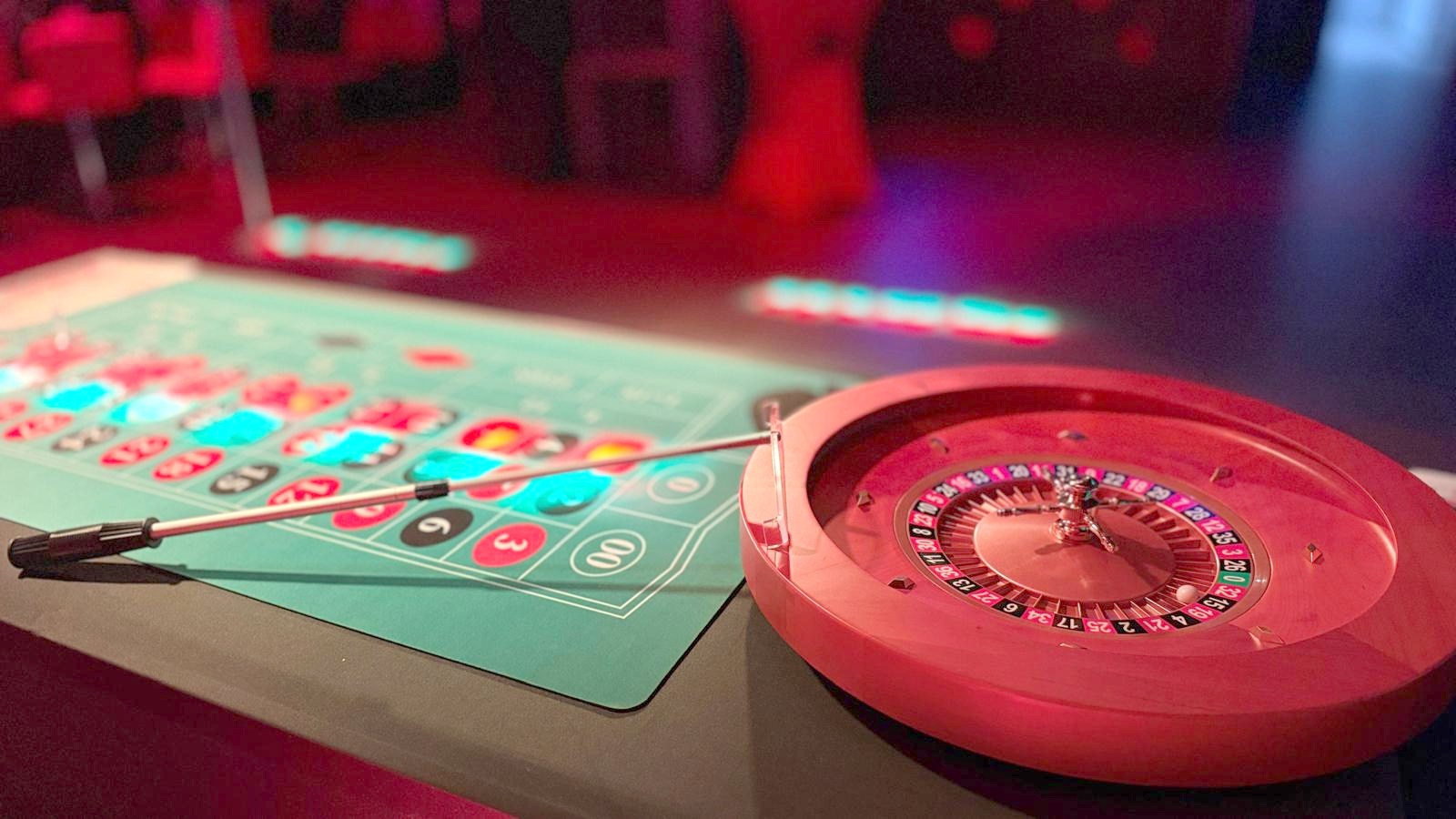 Roulette-Kessel und Spieltisch im roten Partylicht